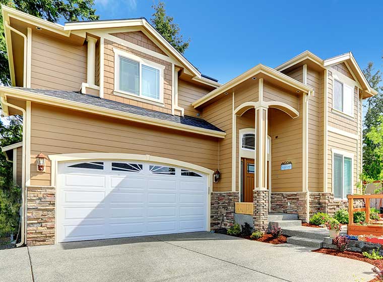 "House with light brown painted vinyl siding"