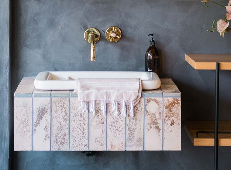 dark dramatic powder room with grey blue walls