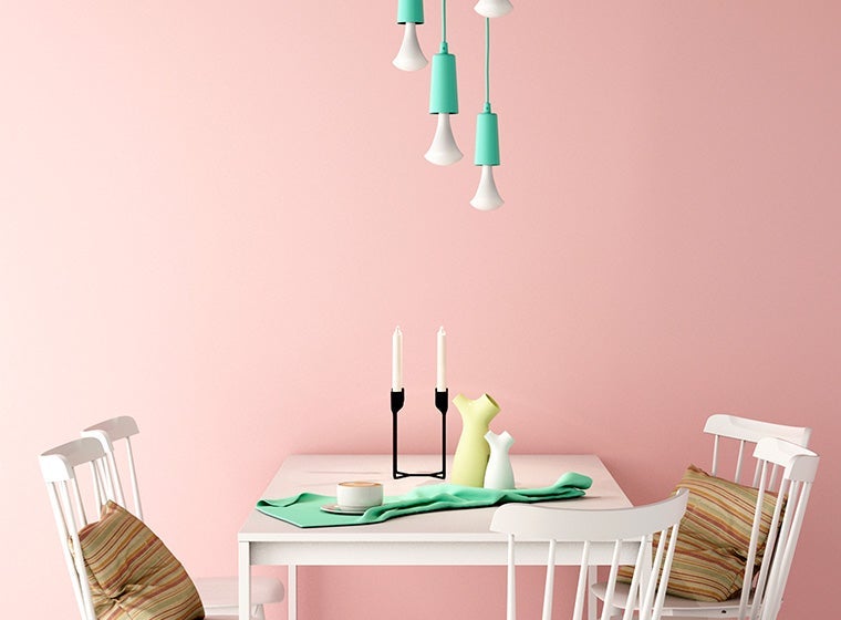 small white table against pink interior wall