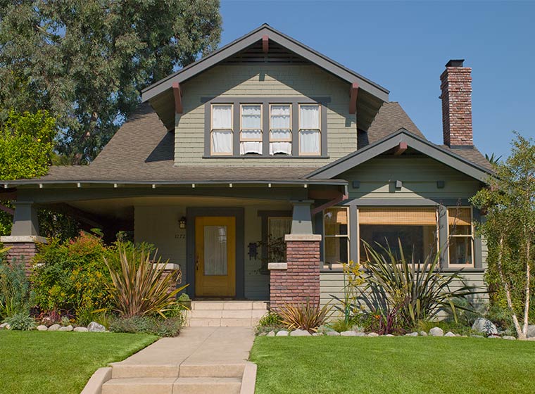 Green exterior home Green exterior home with brick accents