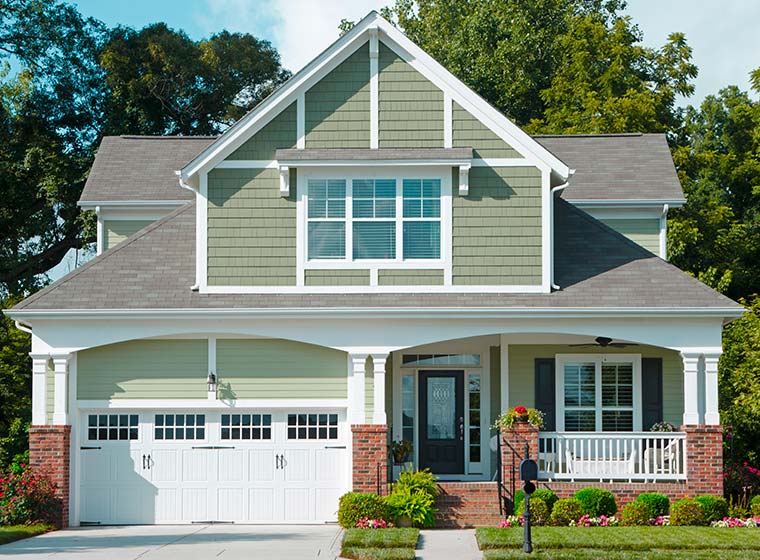 Natural Green exterior home with brick accents