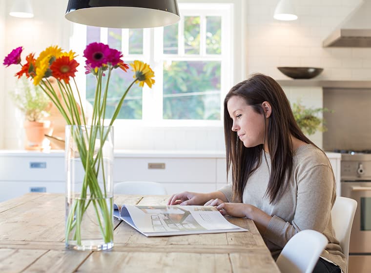 Homeowner looking at painters past work in cateologue