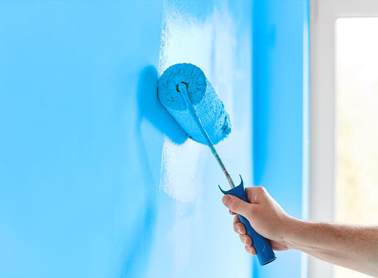 Painting wall skyblue with paint roller