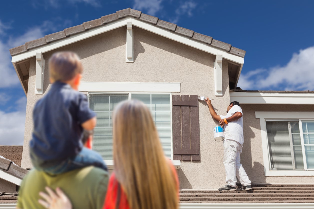 Family watching their home getting painted 