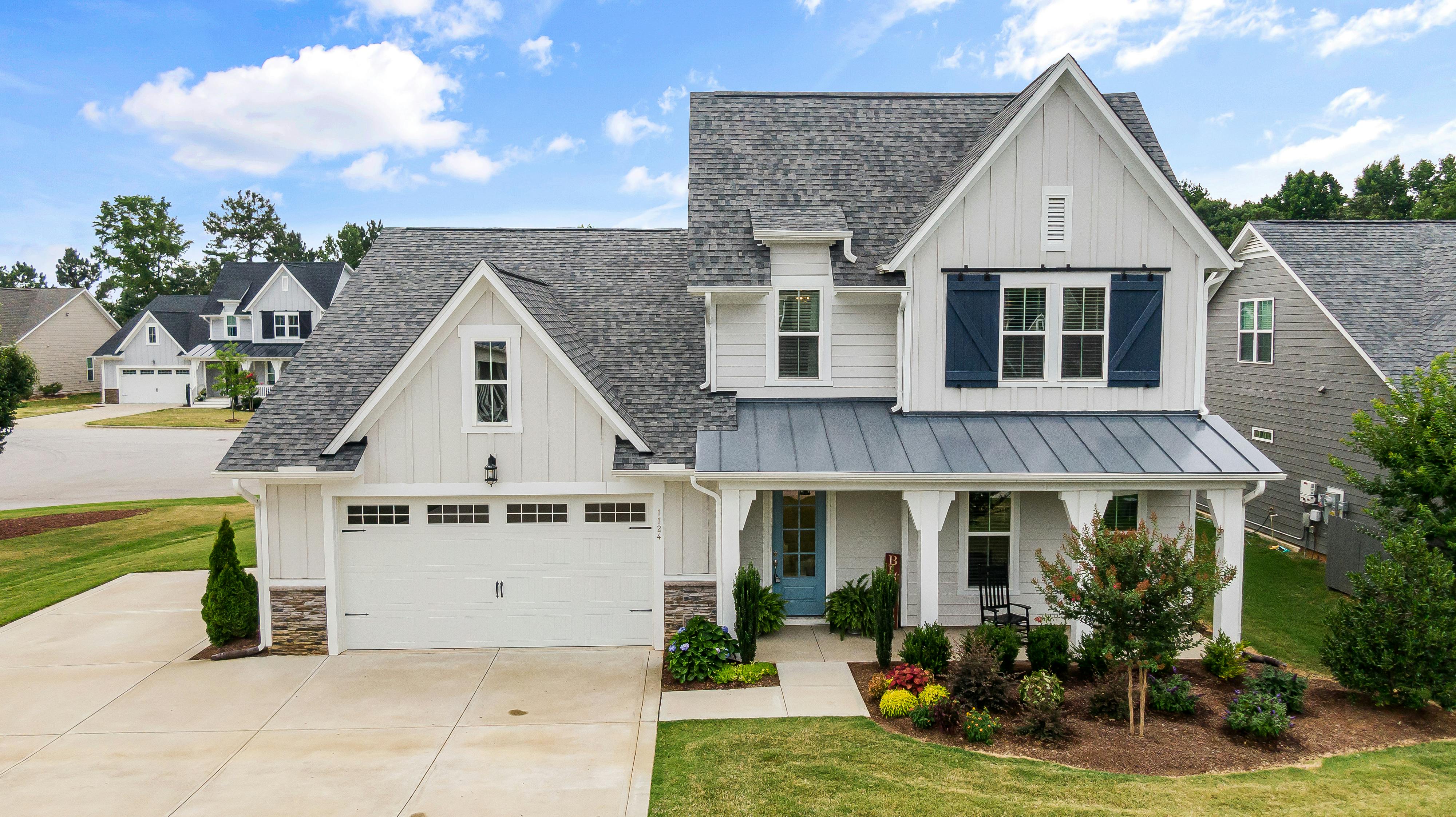 Soft Neutral white exterior house paint with accent color gives the home a modern feel.